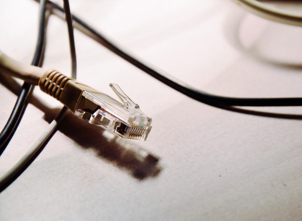 Free Image of Close-up of Ethernet cable connectors lying on surface. 
