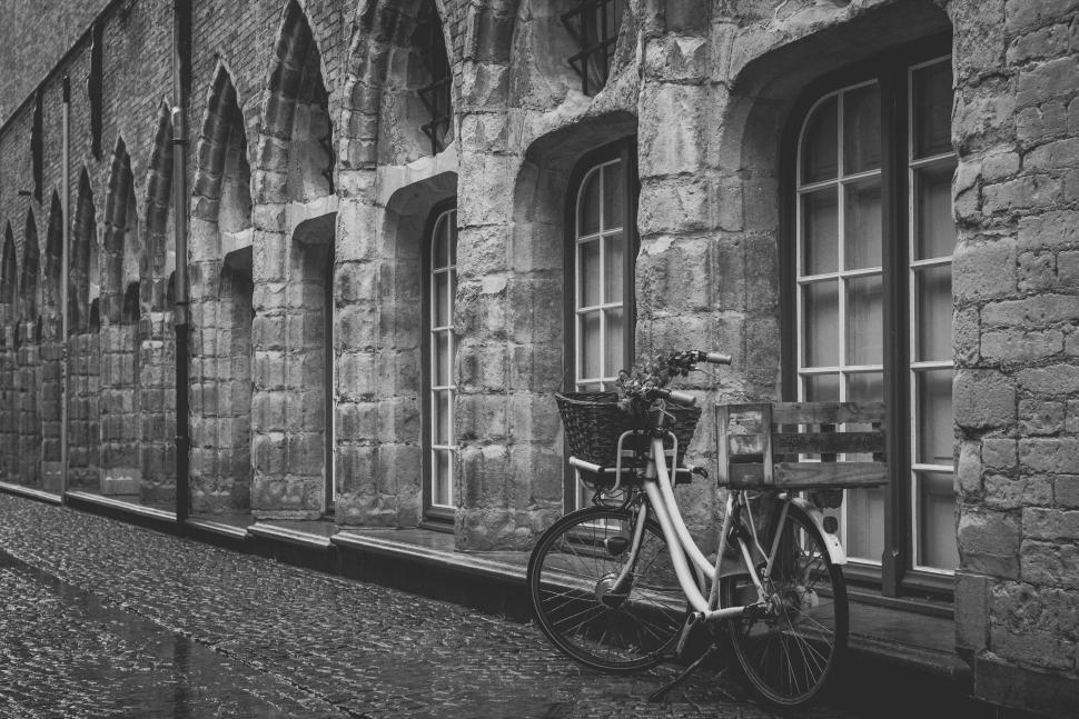 Free Image of Vintage bicycle against old stone wall and windows 
