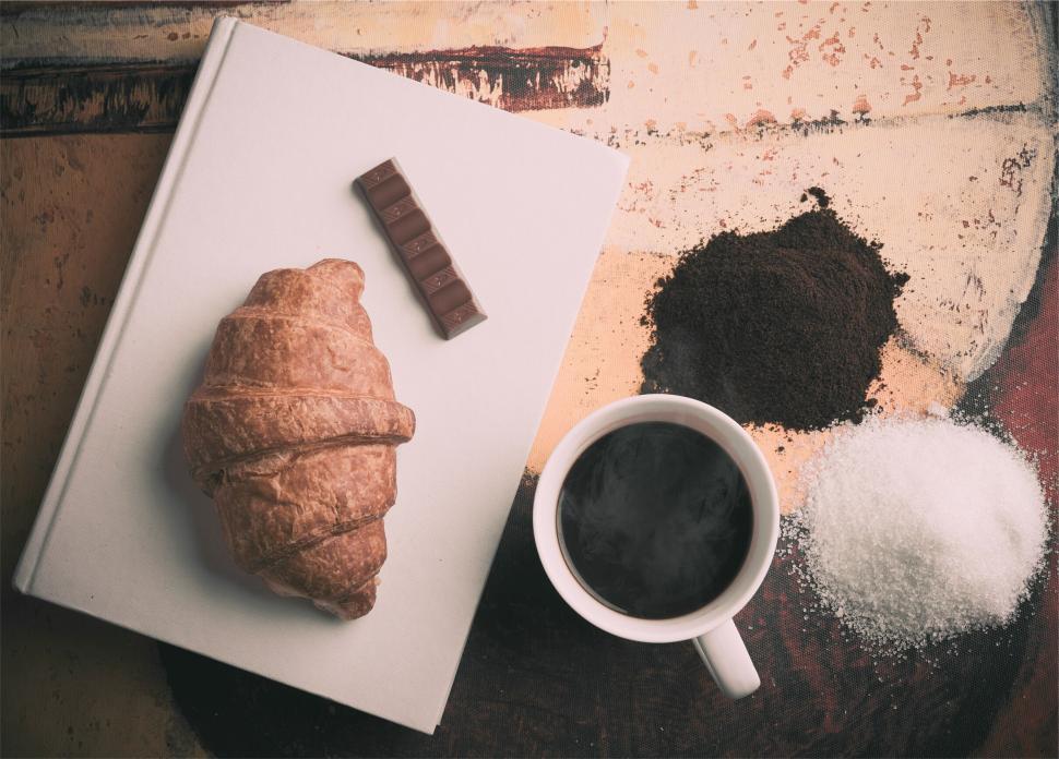 Free Image of Coffee, croissant, chocolate and sugar on a table 
