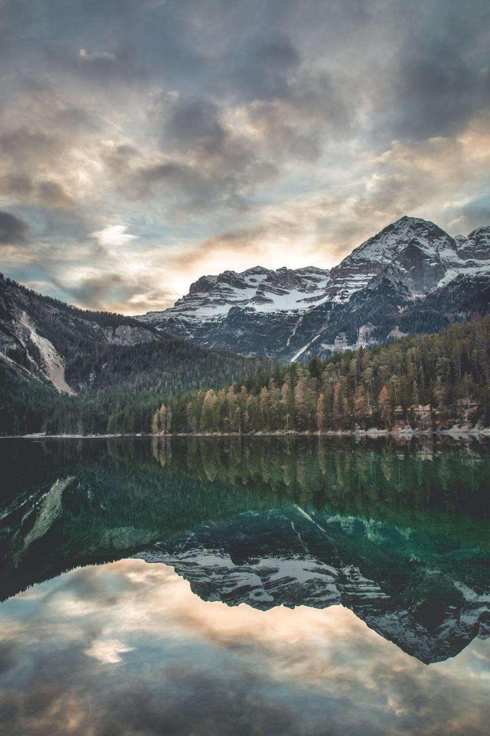 Free Image of Majestic mountain with reflective lake under cloudy sky 