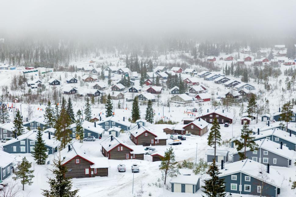 Free Image of Snowy village with houses and foggy background 
