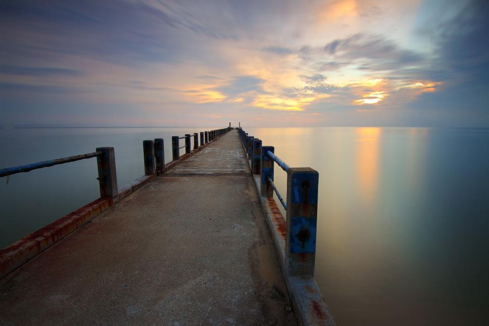 Free Image of Endless pier leading into the horizon at sunset time 