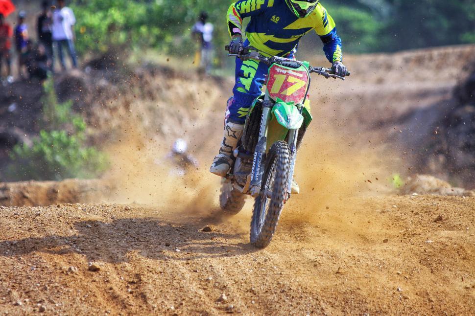 Free Image of Motorcyclist speeds through dirt track in dynamic race 