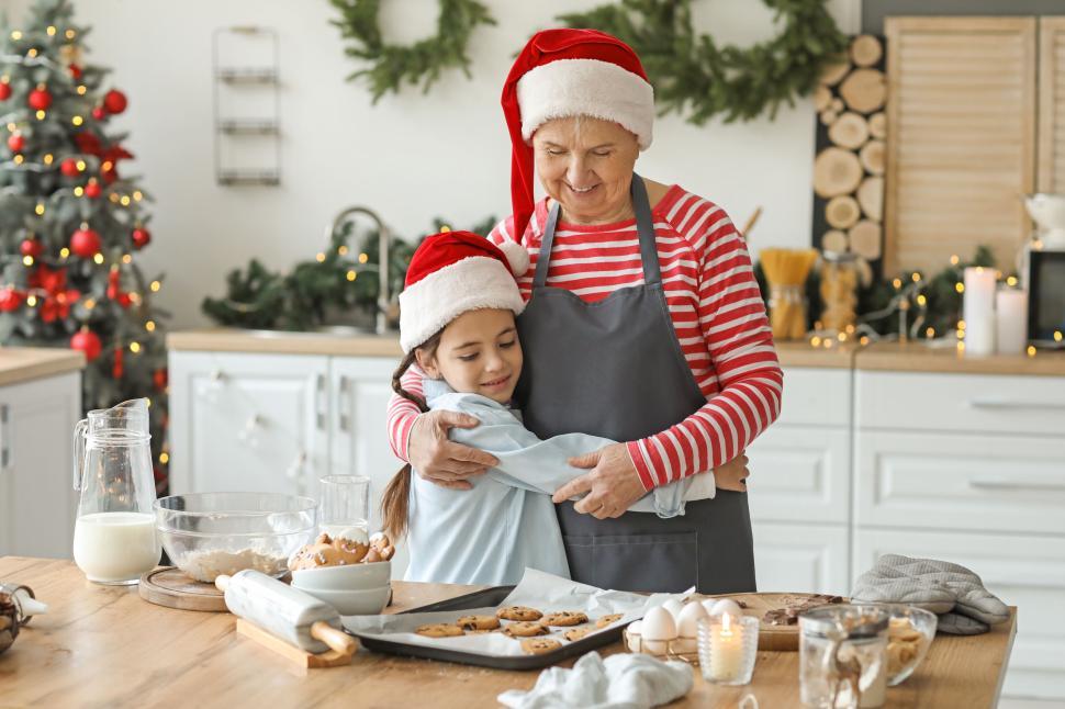 Free Stock Photo of Grandmother and granddaughter hug while baking ...