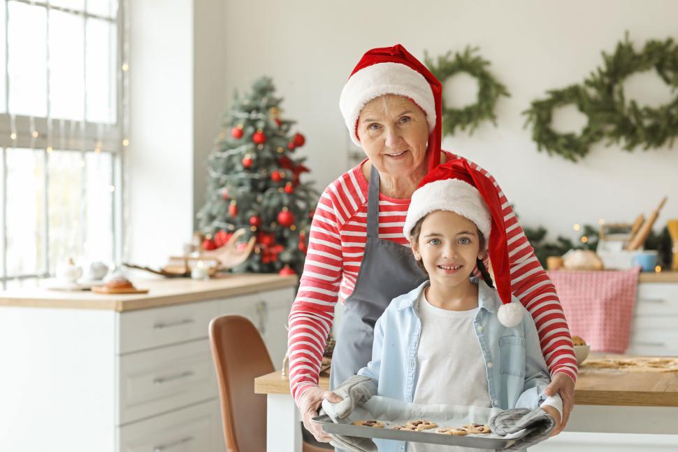 Free Image of Grandmother and child present freshly baked cookies 
