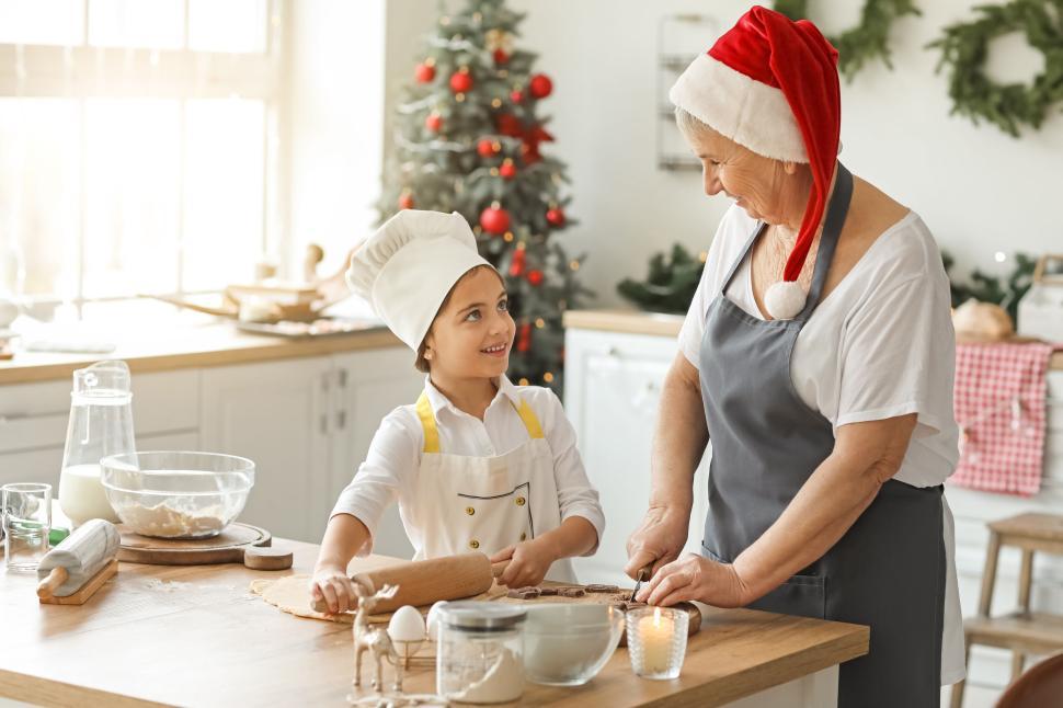 Free Image of Grandmother and child enjoying holiday baking 