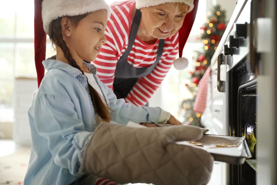 Free Image of Mother and daughter Christmas baking together with joy. 