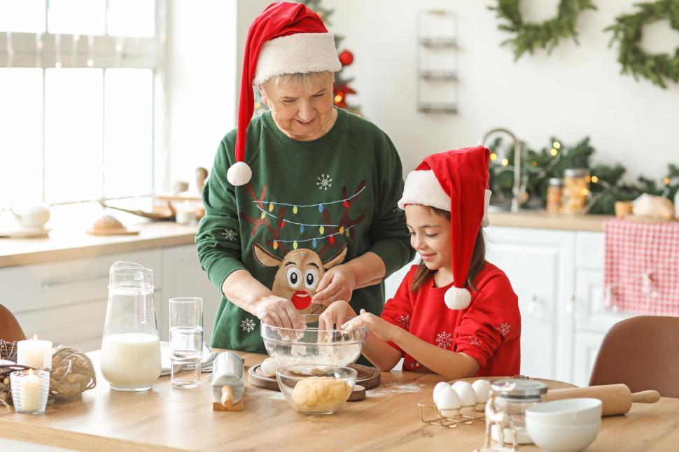 Free Image of Grandmother and granddaughter baking Christmas cookies 