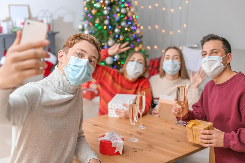 Free Image of Masked friends taking a selfie during holiday celebration 
