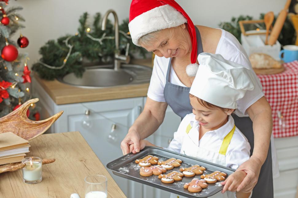 Free Image of Woman and child with cookies in Christmas kitchen 