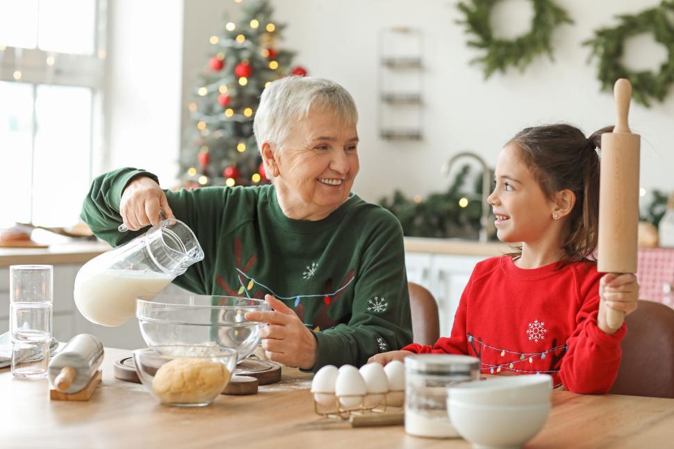 Free Image of Grandmother and granddaughter baking in festive kitchen 