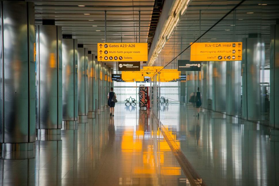 Free Image of Modern airport with walkway and yellow information signs 