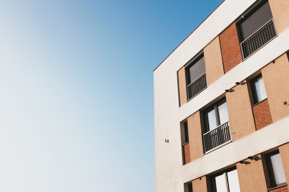 Free Image of Modern apartment building under clear blue sky. 