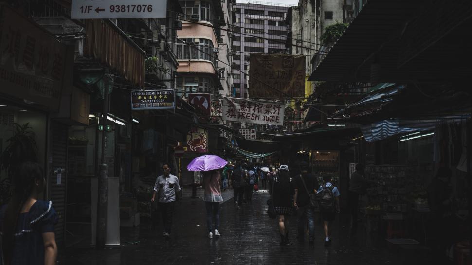 Free Image of City Street Scene With People And Purple Umbrella 