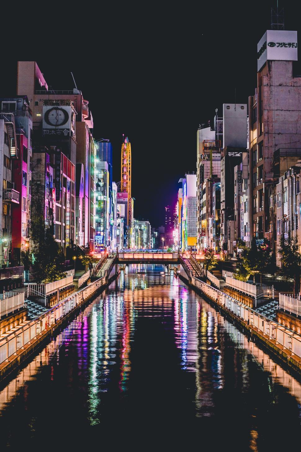 Free Image of Vibrant night cityscape with illuminated buildings and canal. 