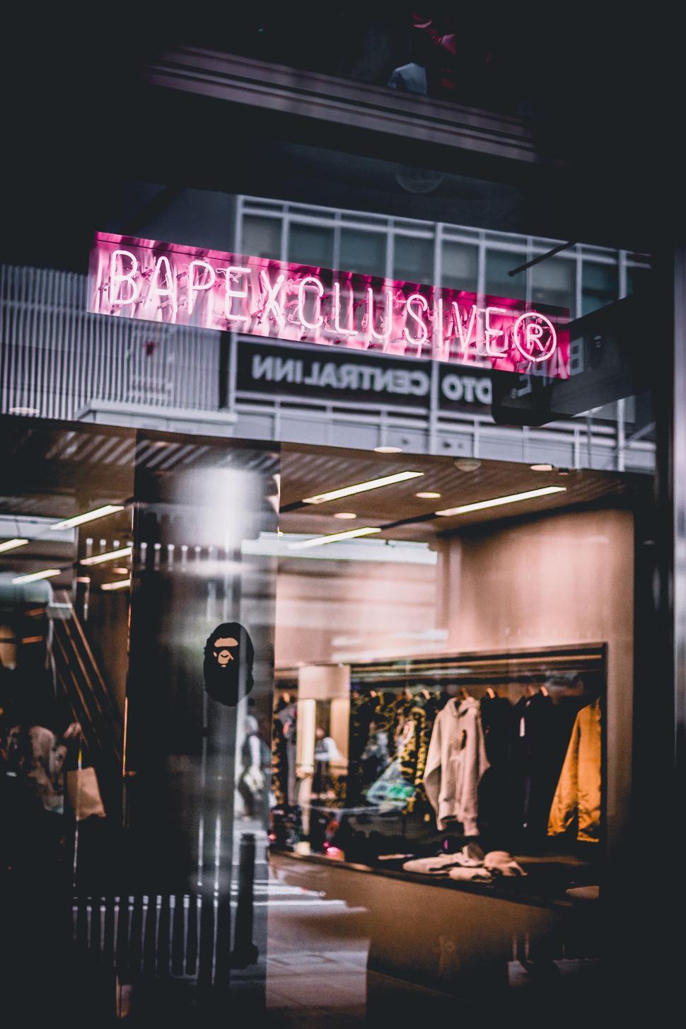 Free Image of Luxury clothing store with neon sign in city center. 