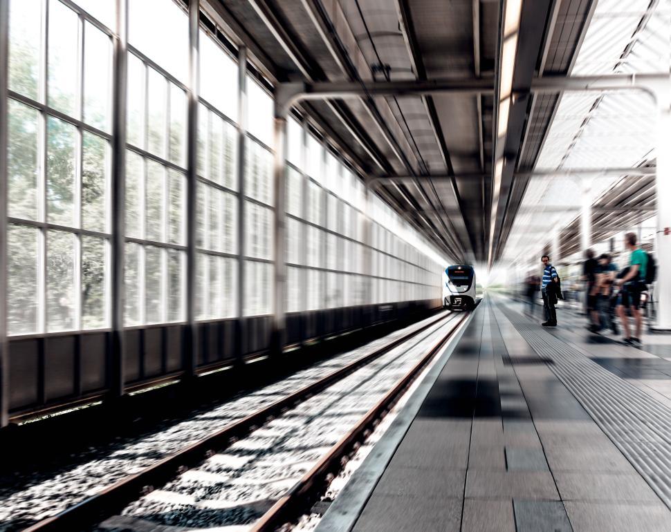 Free Image of High-speed train arriving at a modern station platform 