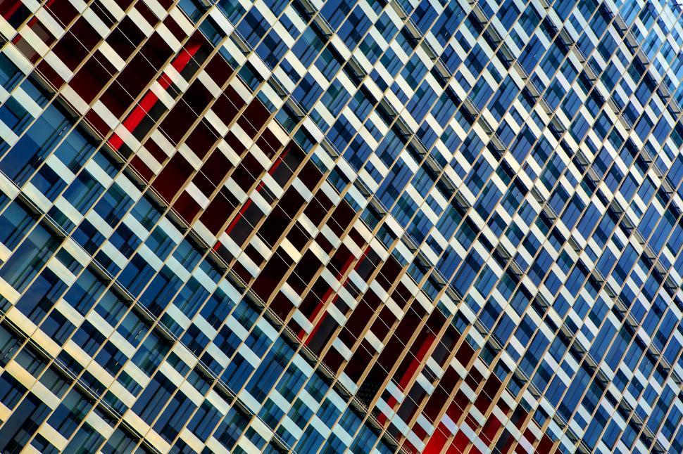 Free Image of Modern building facade with various colorful windows 