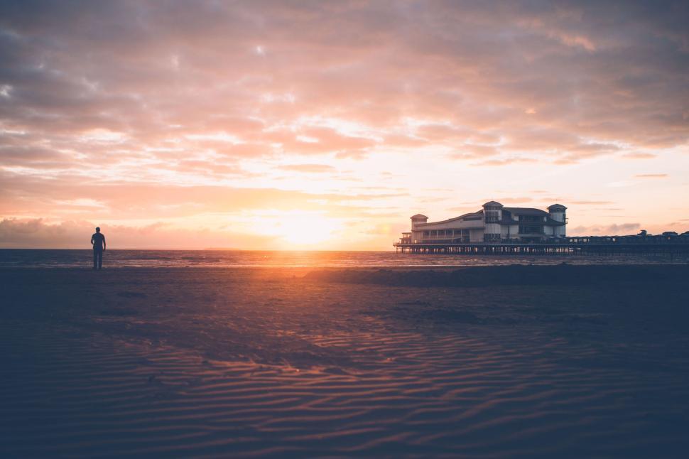 Free Image of Silhouette on the beach during a beautiful sunset view 