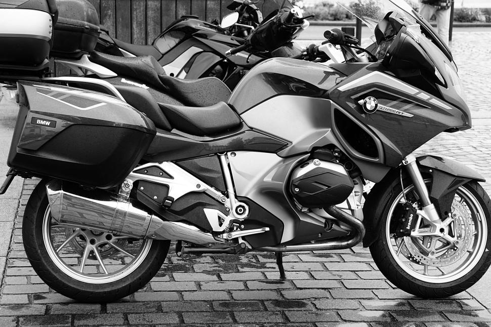 Free Image of BMW motorcycle parked on cobblestone street, sleek design. 