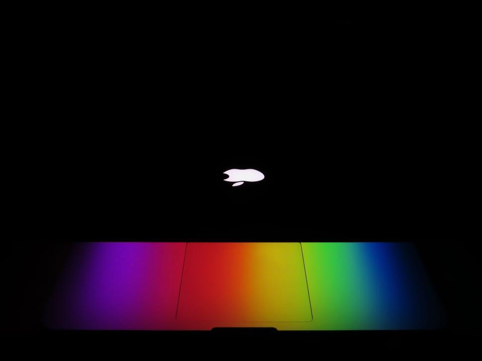 Free Image of Colorful laptop backlit with rainbow hues in darkness 