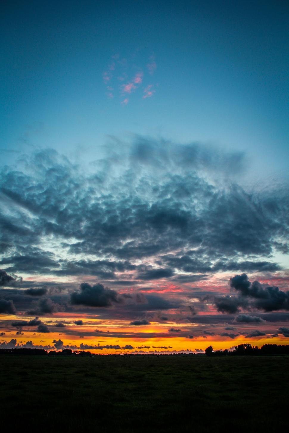 Free Image of Dramatic sunset with multicolored clouds over horizon. 