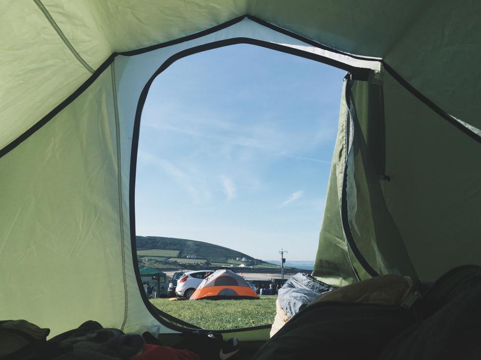 Free Image of View from tent opening to scenic outdoor camping site 