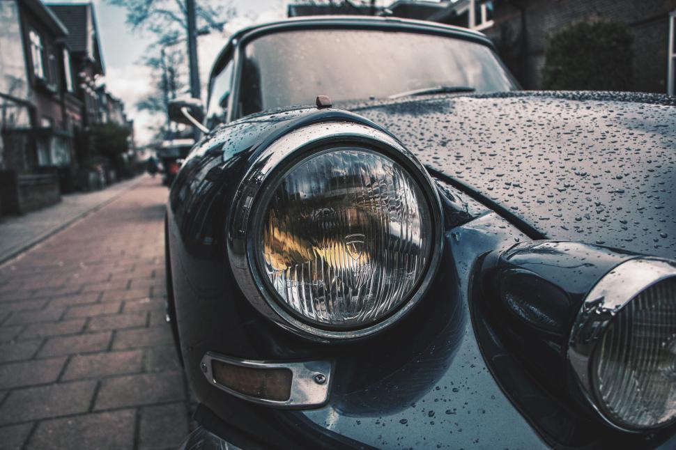 Free Image of Close-up of an old car headlight in rainy weather. 