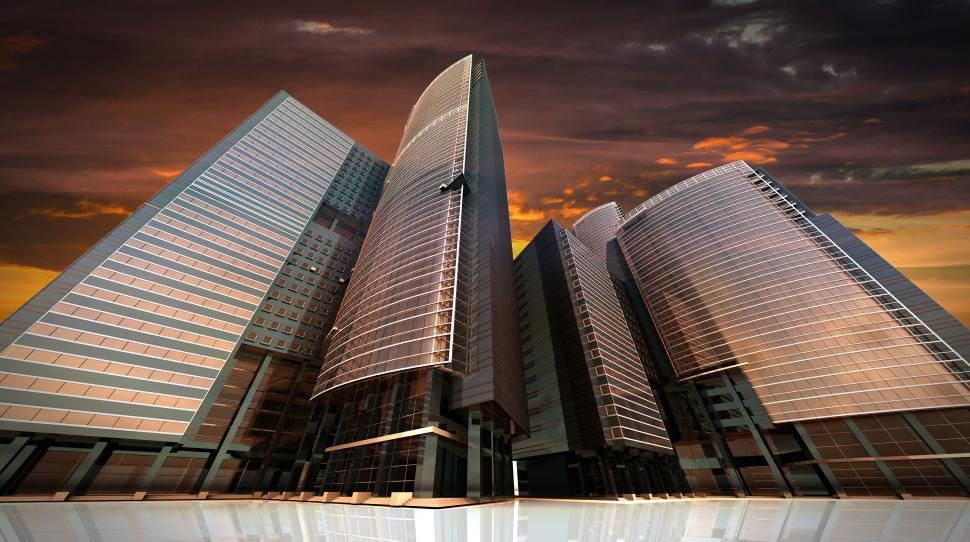 Free Image of Modern glass skyscrapers under an orange dusk sky 