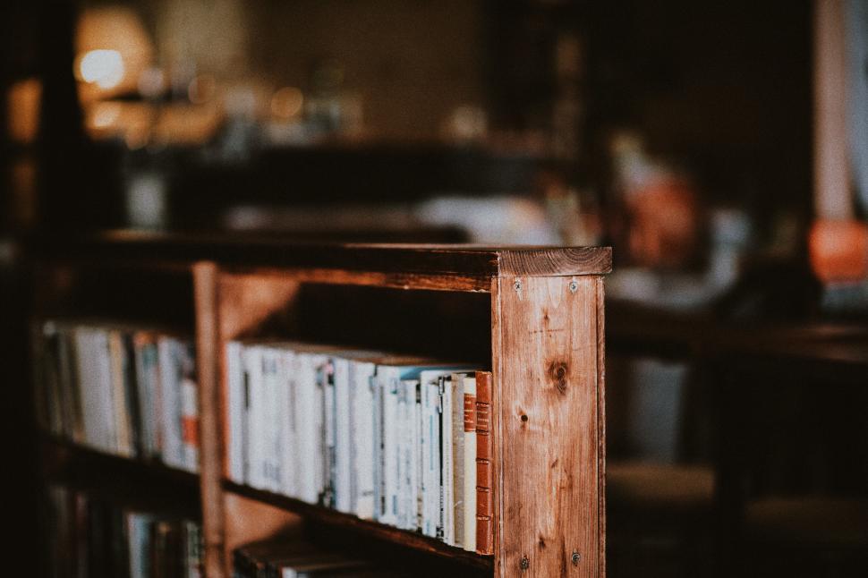 Free Image of Wooden bookshelf filled with books in a cozy room 
