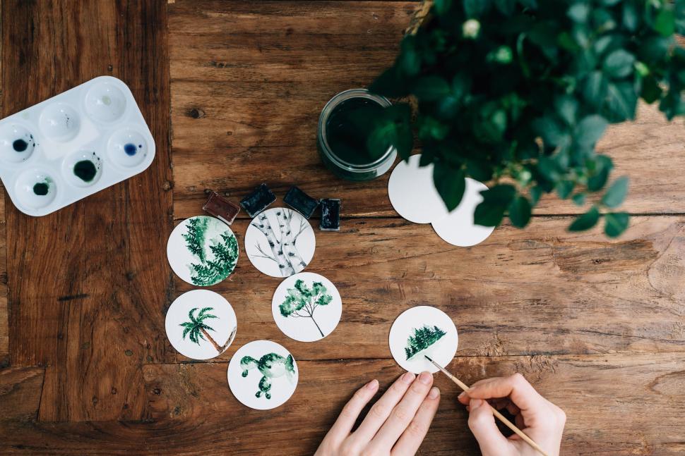 Free Image of Person painting detailed botanical illustrations on table. 