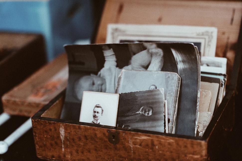 Free Image of Vintage photos in a wooden box, capturing cherished memories. 