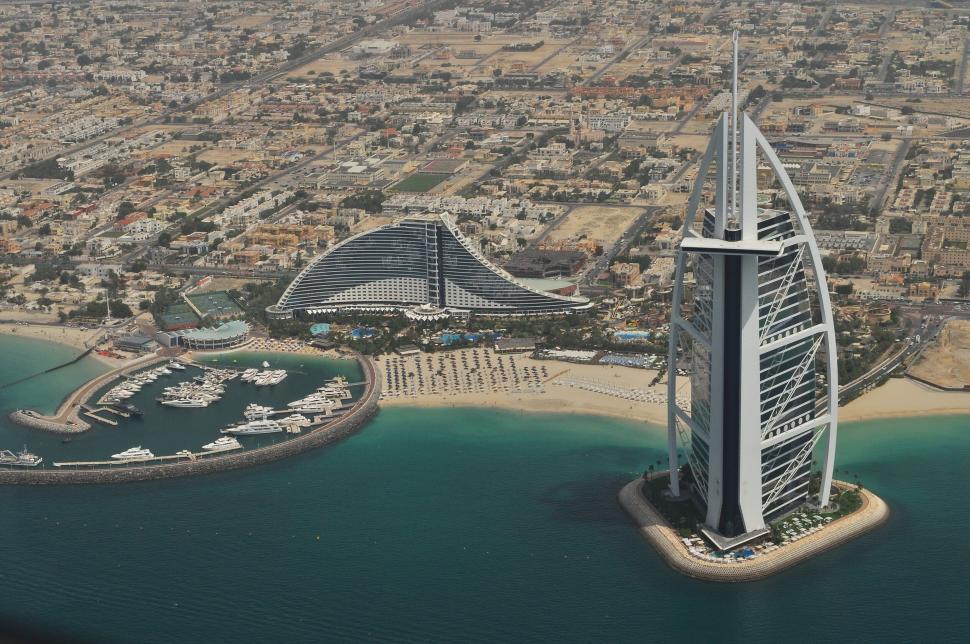 Free Image of Aerial view of Burj Al Arab standing by the coastline 