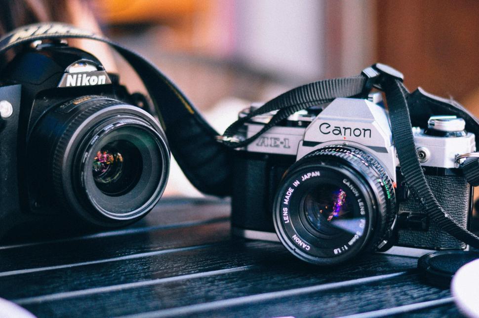 Free Image of Close-up of Nikon and Canon cameras on a dark surface 