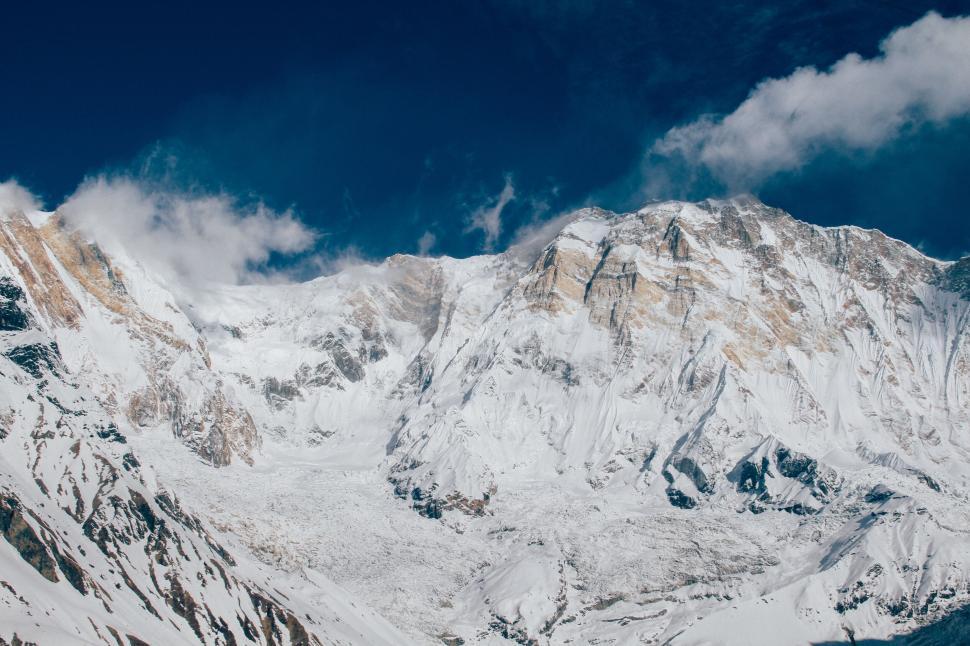 Free Image of Snow-capped mountain range under a clear blue sky 