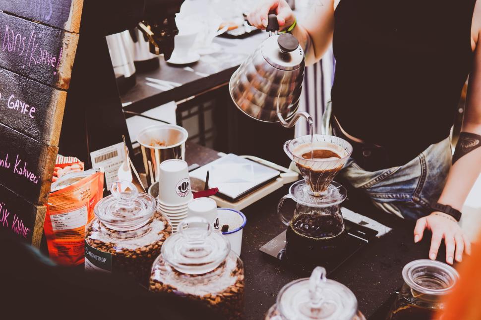 Free Image of Barista pouring hot water over coffee grounds 