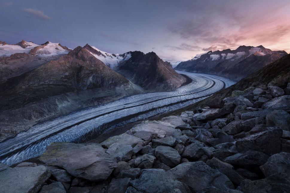 Free Image of Aerial view of winding glacier between mountain ranges. 
