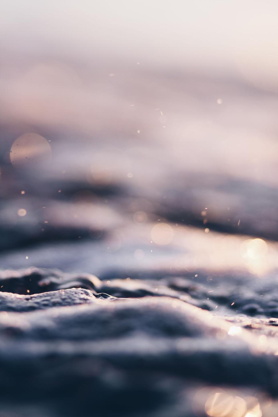 Free Image of Glowing sunlight reflecting on wet beach surface 
