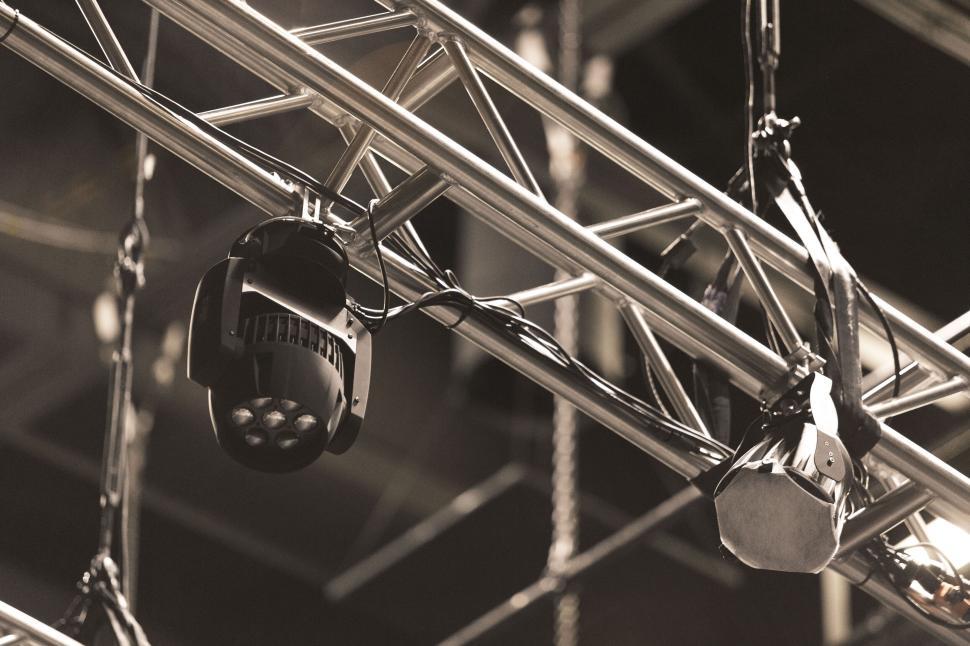 Free Image of Lighting equipment on a metal frame with dangling wires 