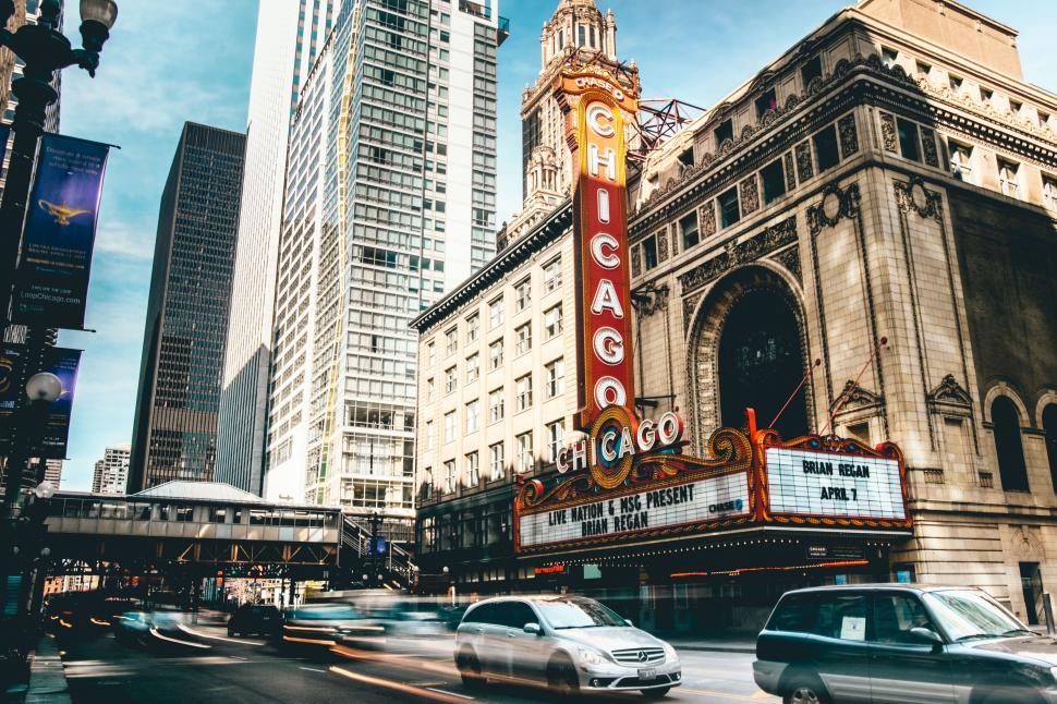 Free Image of Chicago Theatre marquee with illuminated sign and cars. 