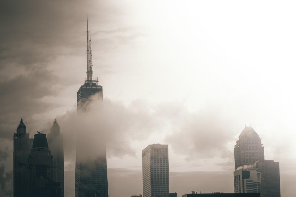Free Image of Chicago skyscrapers in foggy morning light with clouds. 