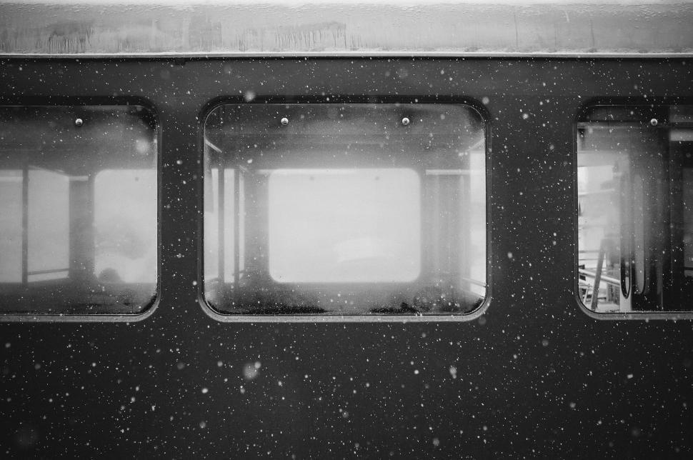 Free Image of Snow-covered train windows reflecting wintery weather scene. 