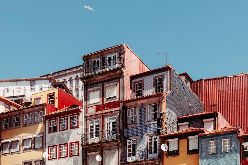 Free Image of Multicolored buildings with balconies under clear blue sky 
