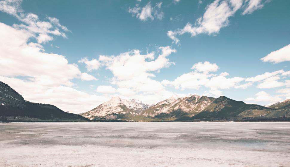 Free Image of Snow-capped mountains and frozen lake under clear sky. 