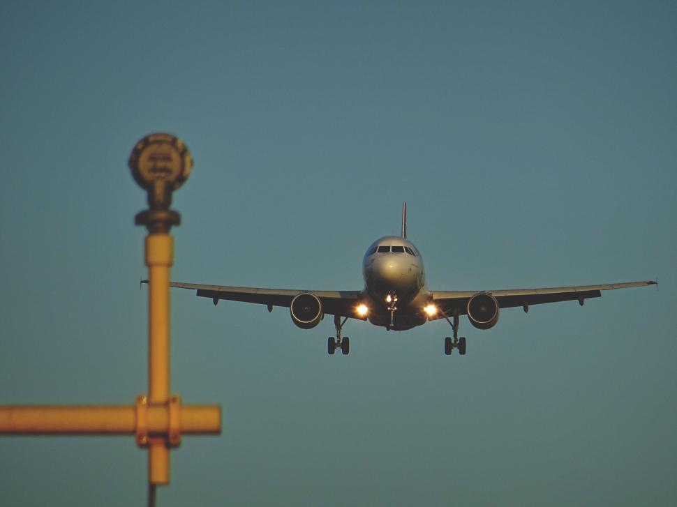 Free Image of Aircraft about to land on runway in early dawn light. 