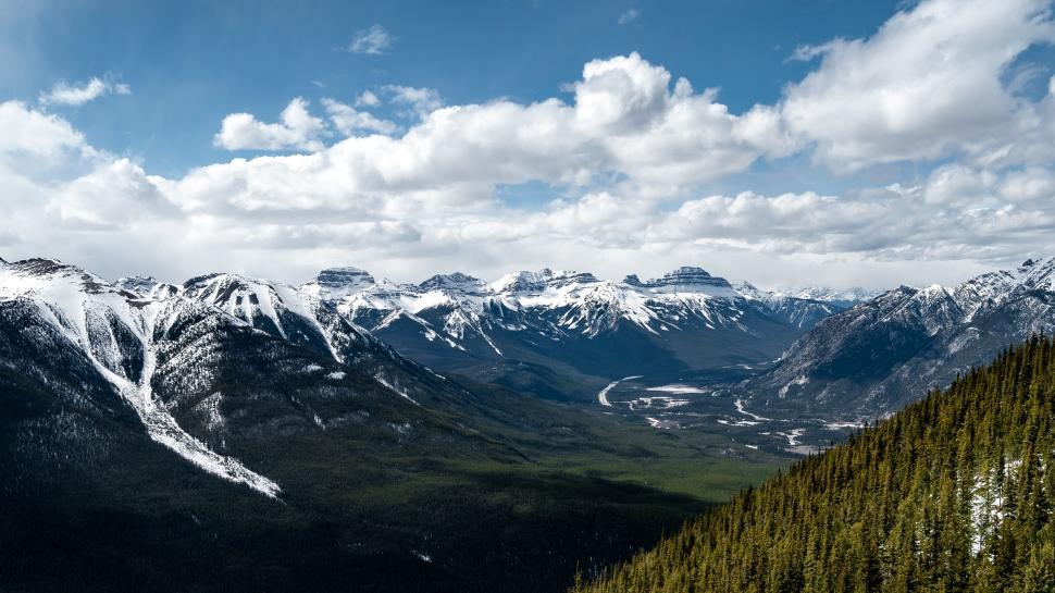 Free Image of Snow-capped mountains under a bright blue sky 
