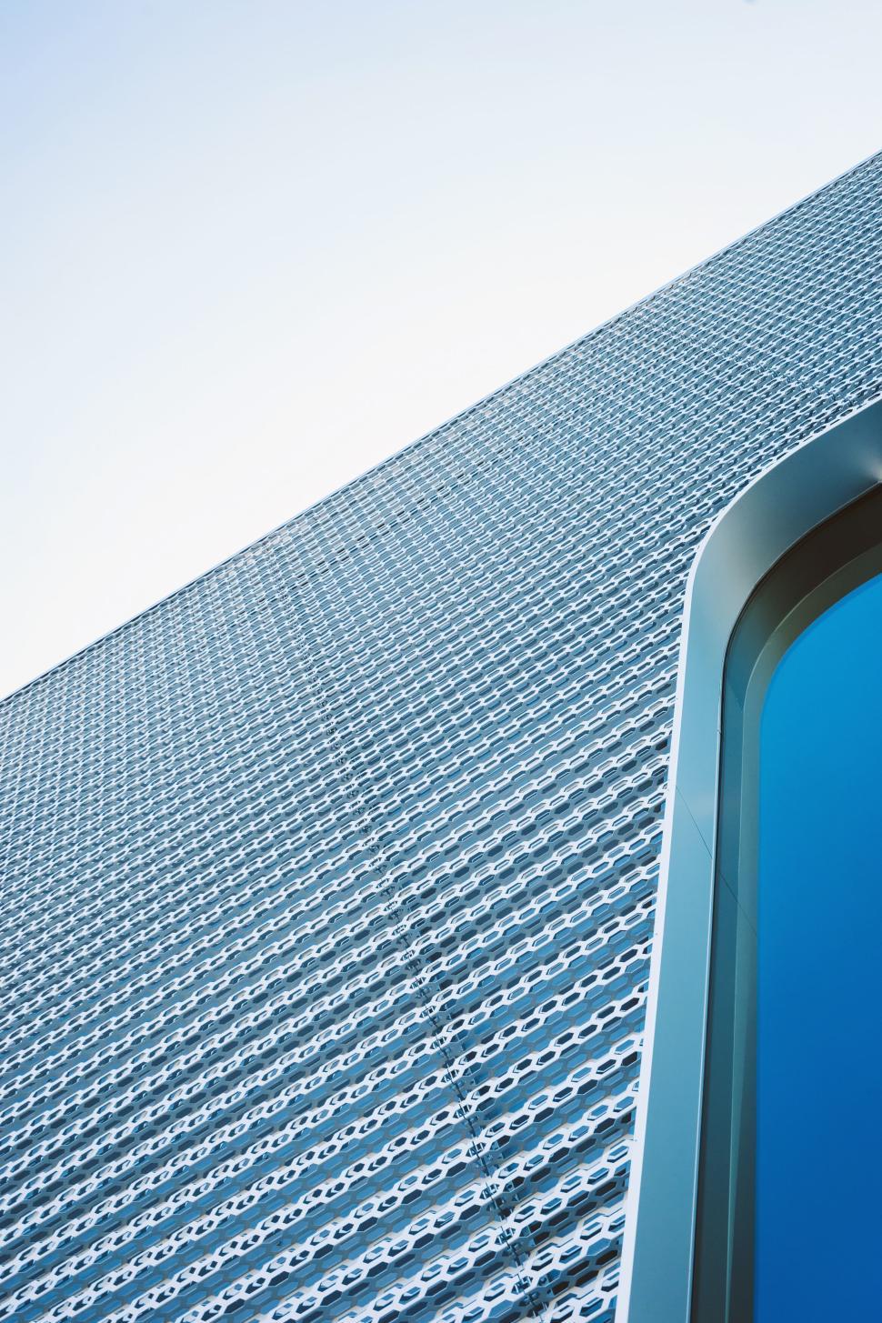 Free Image of Abstract angle of modern metallic building with sky view 
