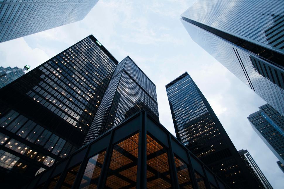 Free Image of Modern skyscrapers reaching towards the cloudy sky 