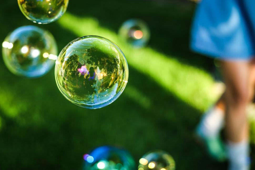 Free Image of Close-up of bubbles floating gently in a grassy area. 