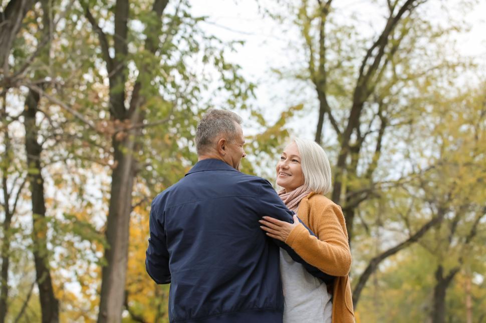 Free Image of Elderly couple enjoying a walk in an autumn park. 
